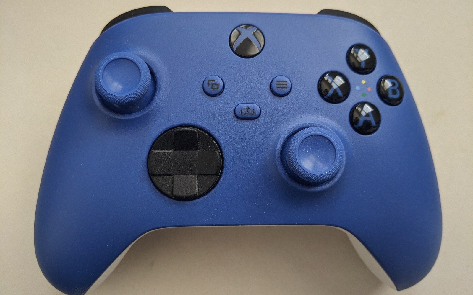 Blue Xbox wireless controller with joysticks, d-pad and face buttons visible from above